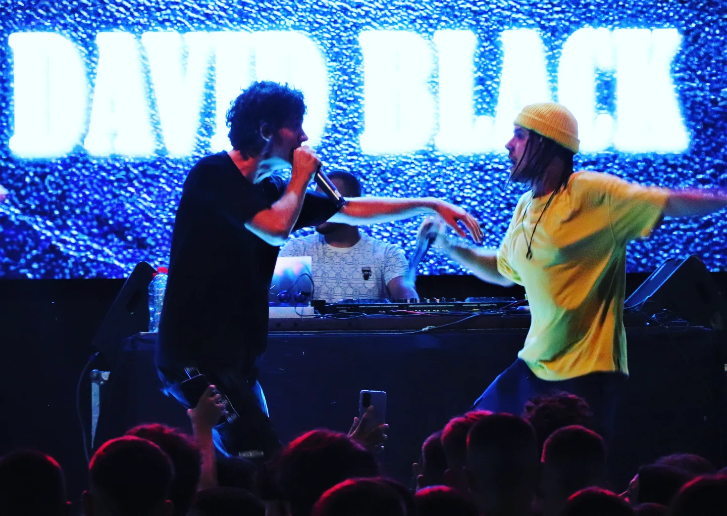 David Black performing on stage with a guest